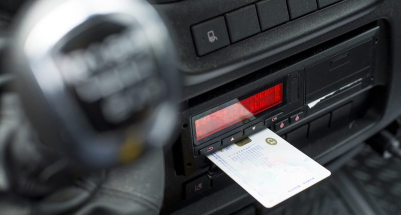 Digital tachograph in a van from an angle with ejected driver card.