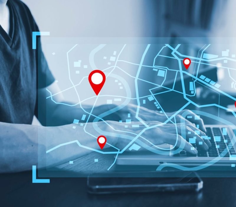 man-using-laptop-with-virtual-world-model-map-with-location-point-gps-app-icon-travel-maps-find-places-online-system-all-screen-graphics-are-generatedsearching-travel-scaled.jpg